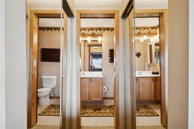 a bathroom with a glass shower door and a toilet