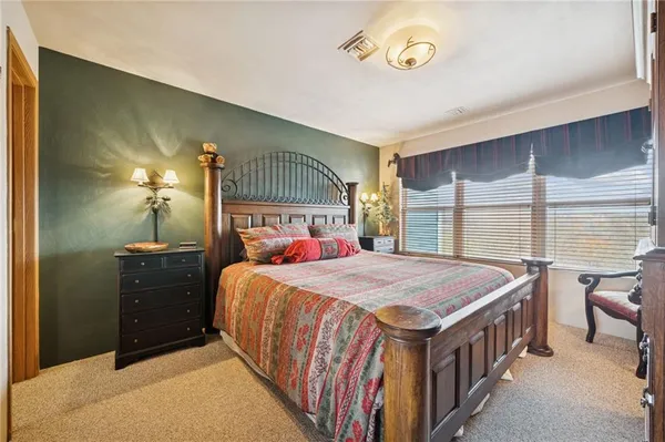 a bedroom with a bed and a table in it