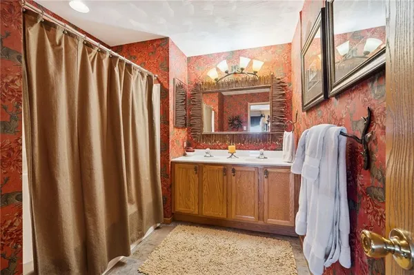 a bathroom with a double vanity sink and mirror