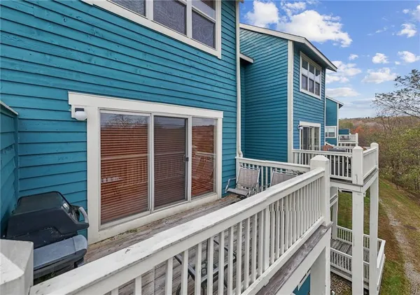 a view of a house with a window and wooden fence