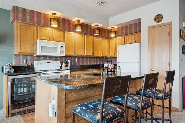 a kitchen with a stove a refrigerator and a dining table