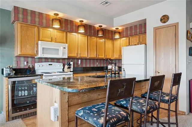 a kitchen with a stove a refrigerator and a dining table