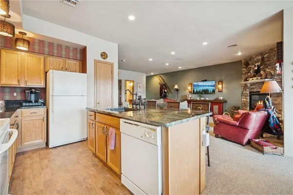 a kitchen with refrigerator and cabinets
