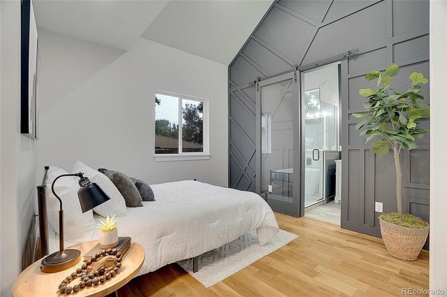 a bedroom with bed and a window