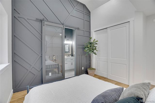 a bedroom with a bed and a potted plant