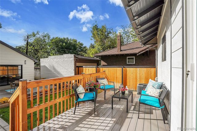 a balcony with table and chairs
