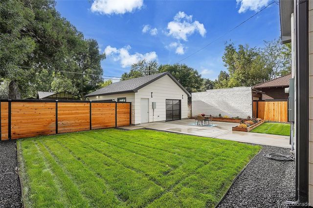 a view of a house with a yard and a garden