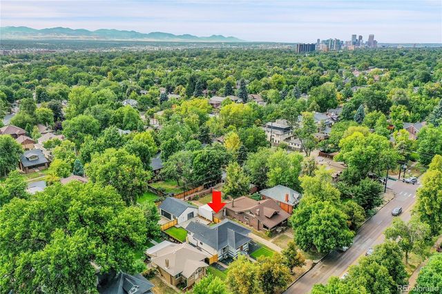 an aerial view of a house with a yard and lake view