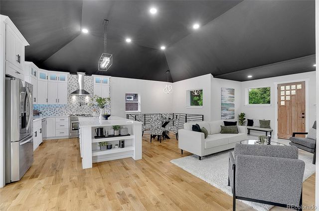 a living room with fireplace furniture and a flat screen tv