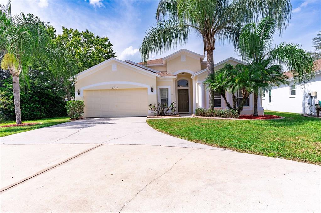 34751 Prairie Ridge Way Zephyrhills, FL 33541 - Photo 1 of 1 a front view of house with yard and green space