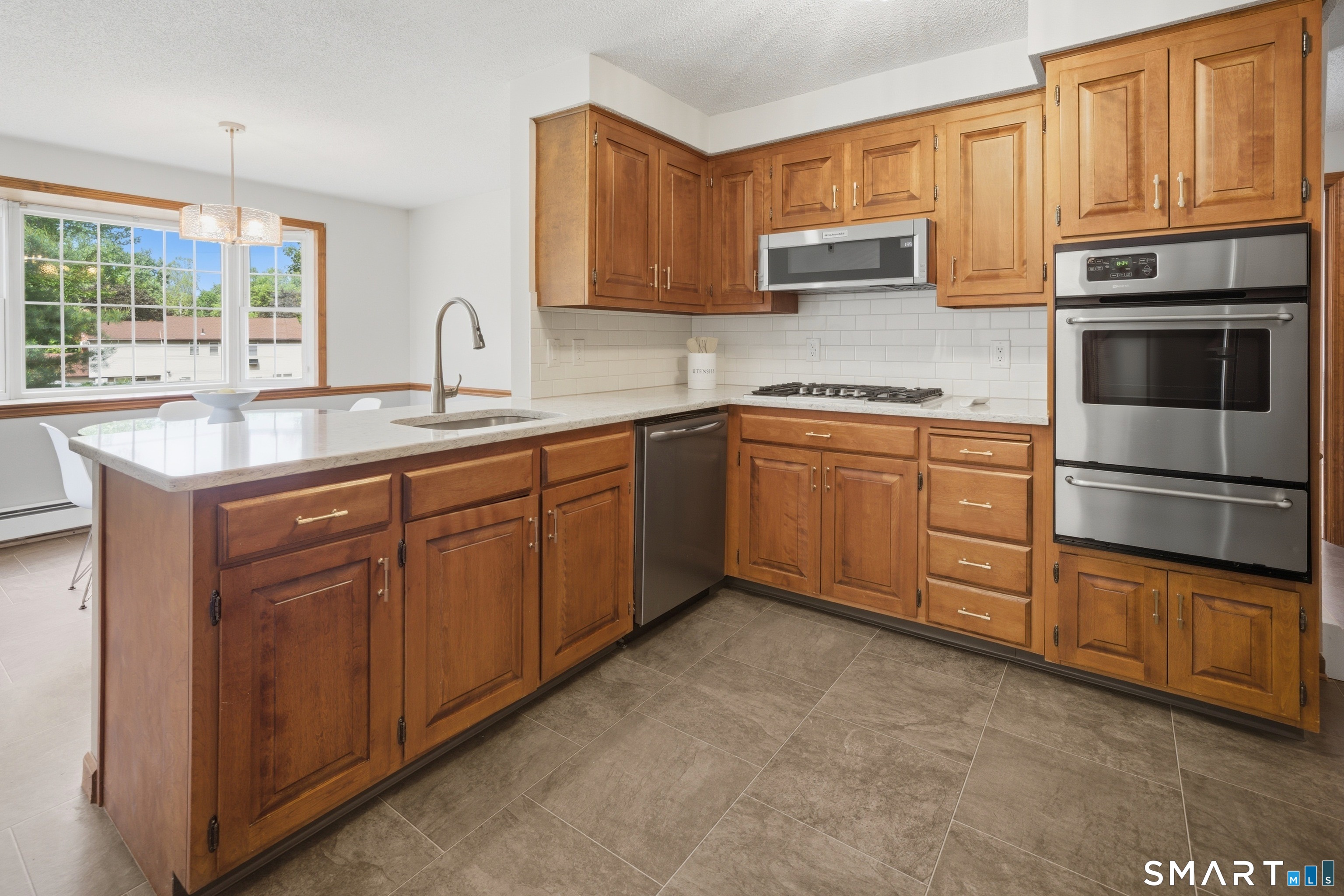 211 Valley View Road Manchester, CT 06040 - Photo 10 of 39 a kitchen with stainless steel appliances granite countertop a sink stove and microwave