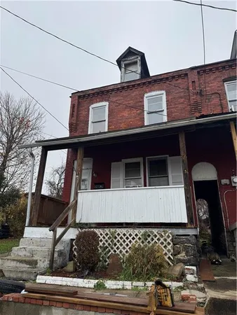 a front view of a house with large windows