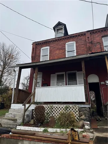 a front view of a house with large windows