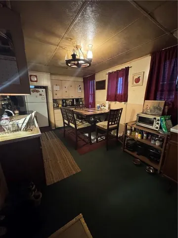 a living room with lots of furniture and a chandelier