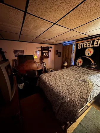 a bedroom with a bed and a car