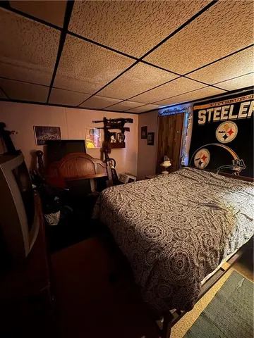 a bedroom with a bed and a car