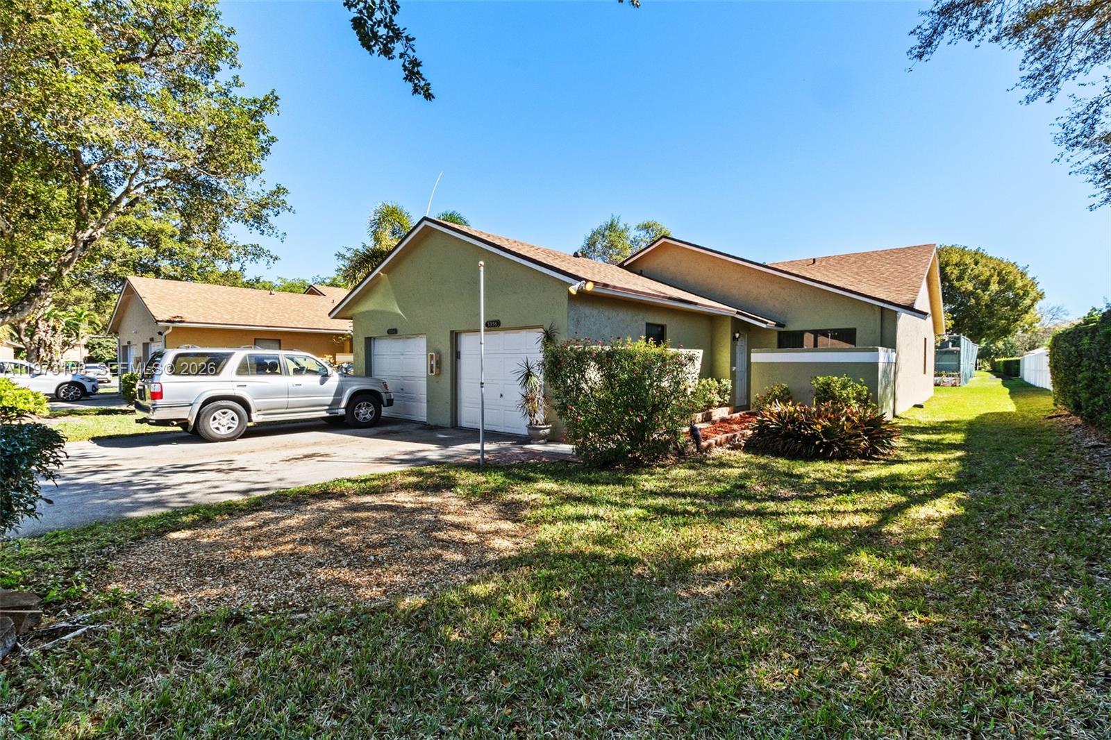 5356 Gate Lake Road, Unit 5356 Tamarac, FL 33319 - Photo 1 of 25 a front view of a house with a yard