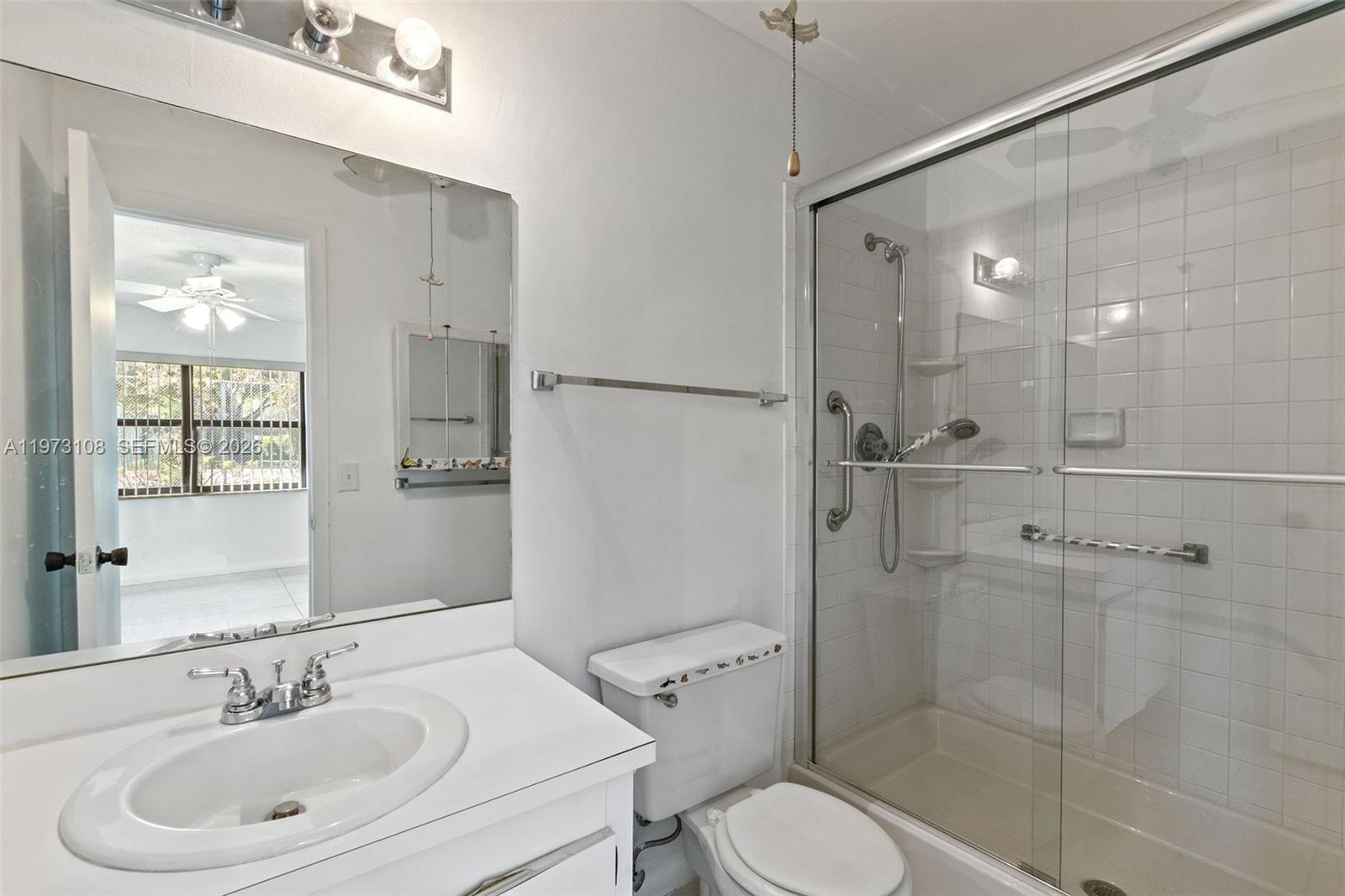 5356 Gate Lake Road, Unit 5356 Tamarac, FL 33319 - Photo 12 of 25 a bathroom with a sink toilet and shower