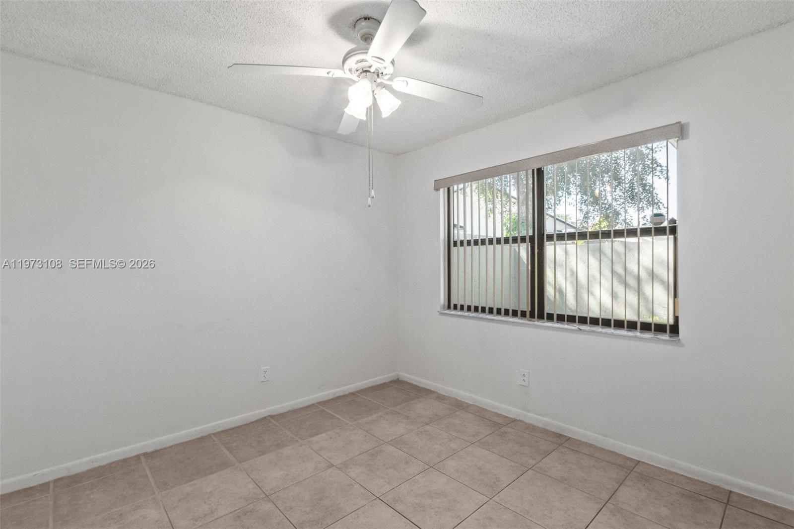 5356 Gate Lake Road, Unit 5356 Tamarac, FL 33319 - Photo 14 of 25 an empty room with windows and fan