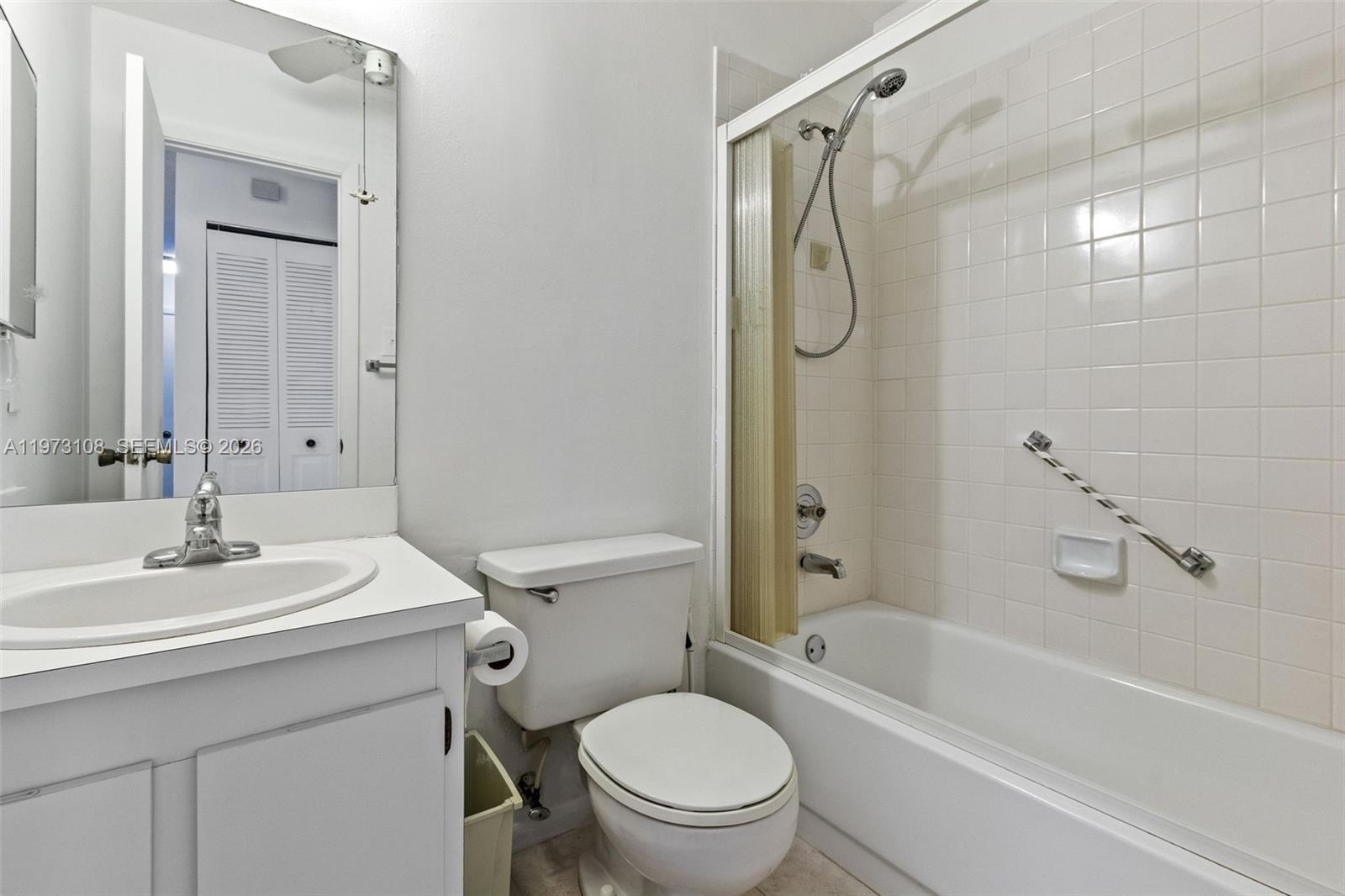 5356 Gate Lake Road, Unit 5356 Tamarac, FL 33319 - Photo 16 of 25 a bathroom with a sink toilet and shower