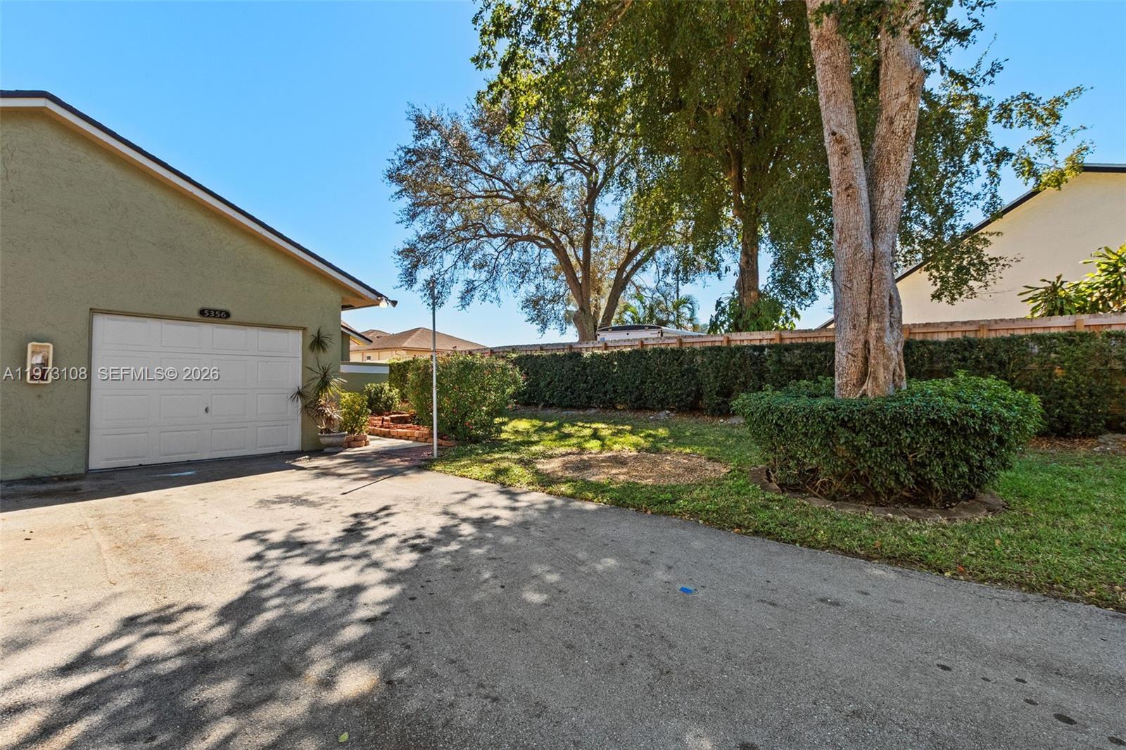 5356 Gate Lake Road, Unit 5356 Tamarac, FL 33319 - Photo 2 of 25 a view of a house with a yard and garage