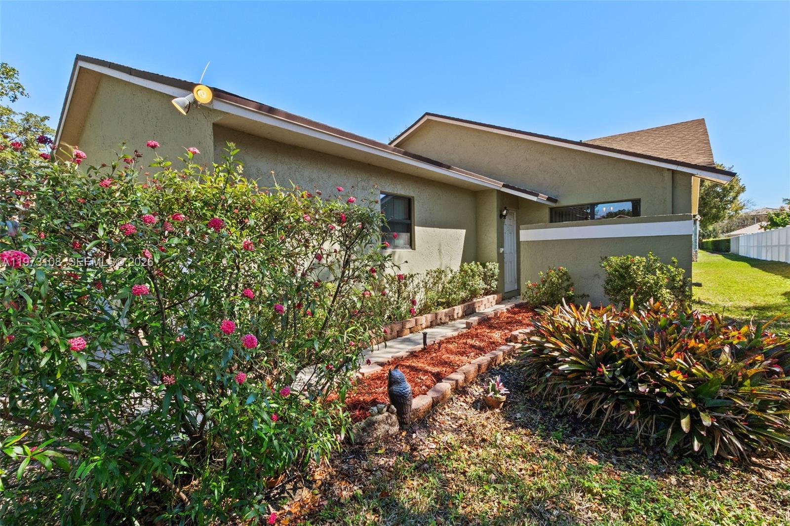 5356 Gate Lake Road, Unit 5356 Tamarac, FL 33319 - Photo 23 of 25 a view of a house with a flower garden