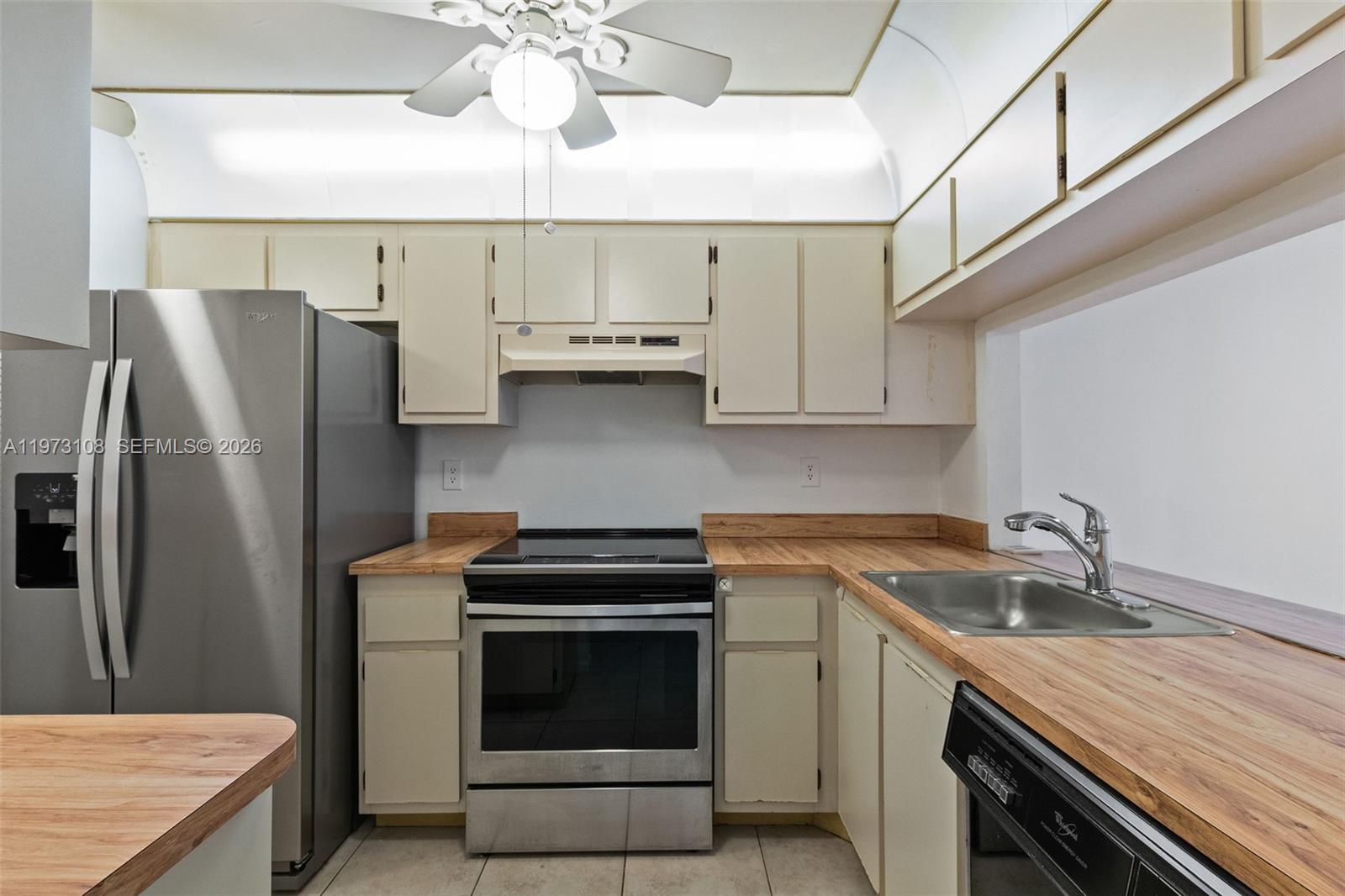 5356 Gate Lake Road, Unit 5356 Tamarac, FL 33319 - Photo 6 of 25 a kitchen with stainless steel appliances white cabinets and a sink