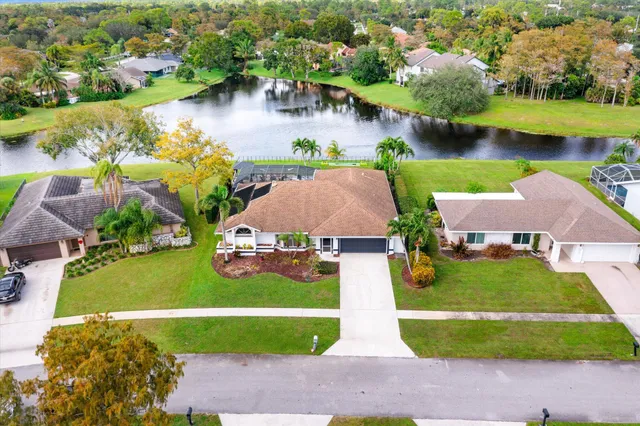 an aerial view of a house with a lake view