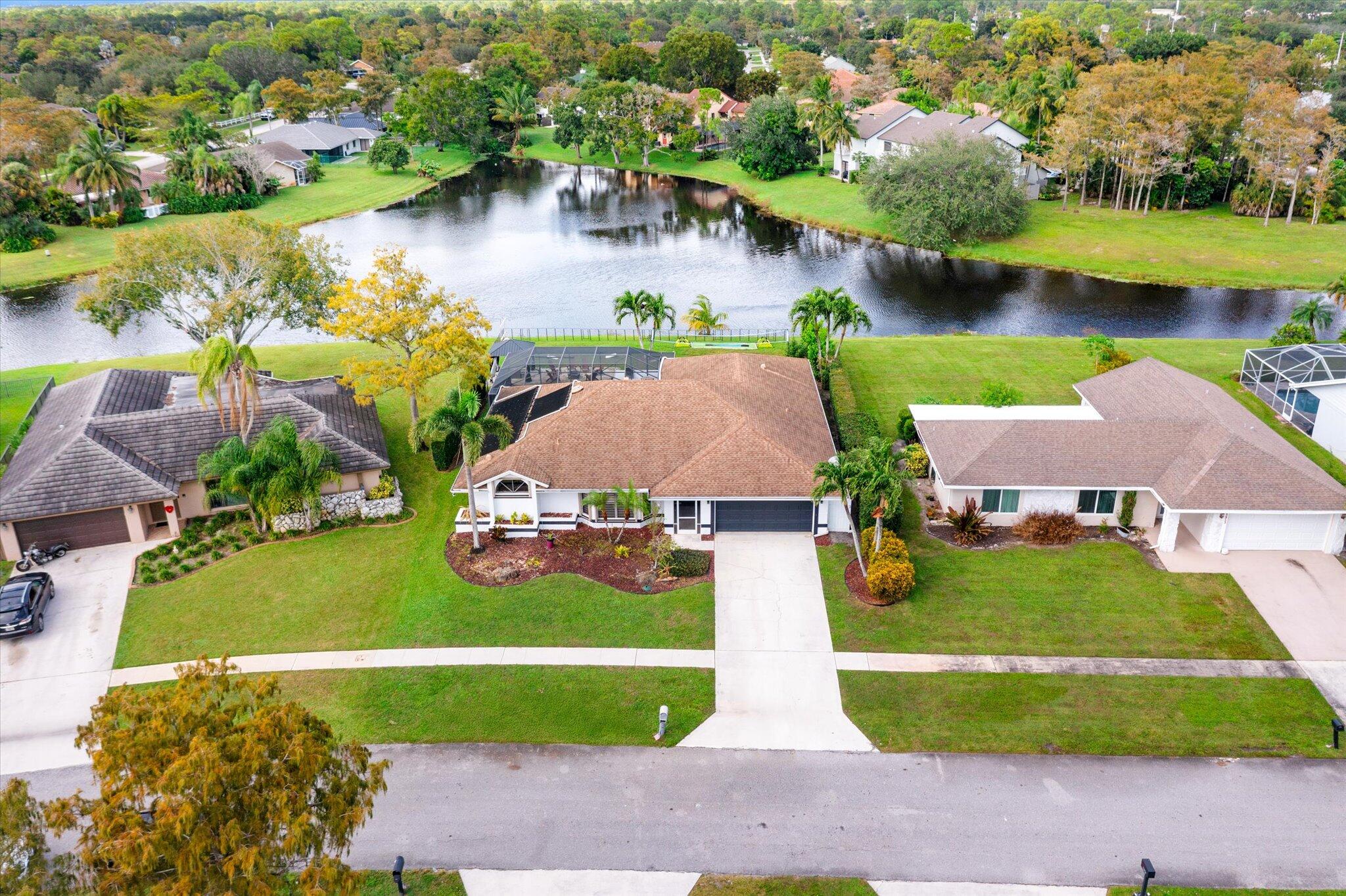 an aerial view of a house with a lake view