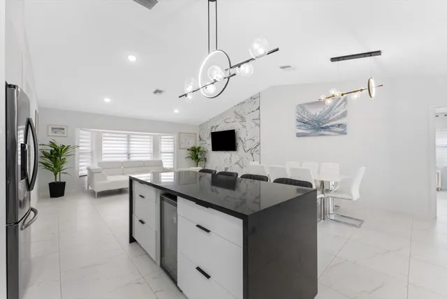 a kitchen with a counter top space a sink and appliances