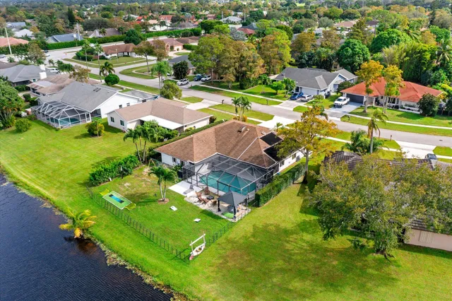 an aerial view of residential houses with outdoor space and lake view