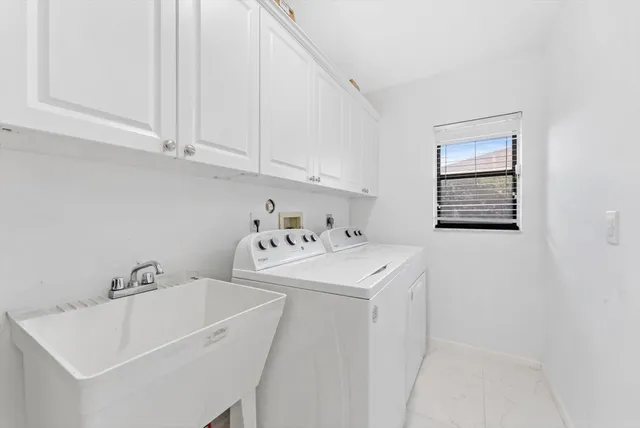 a view of a hallway that has a table and a chair in it