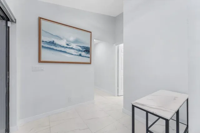 a bedroom with a bed and a large mirror