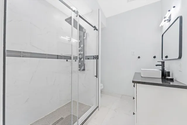 a bathroom with a shower and a toilet