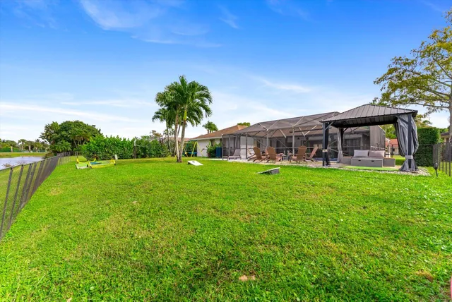 an aerial view of a house with a garden and lake view