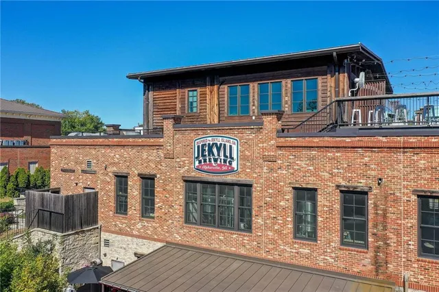 front view of a brick house with a large window