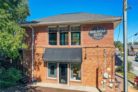 a group of people sitting in front of a building