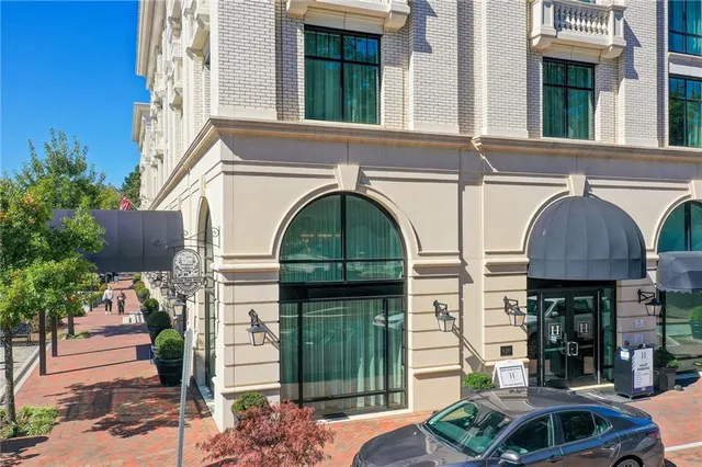 a view of a patio with table and chairs and potted plants