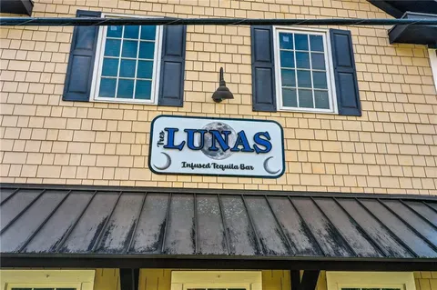 an aerial view of residential house with outdoor space and swimming pool