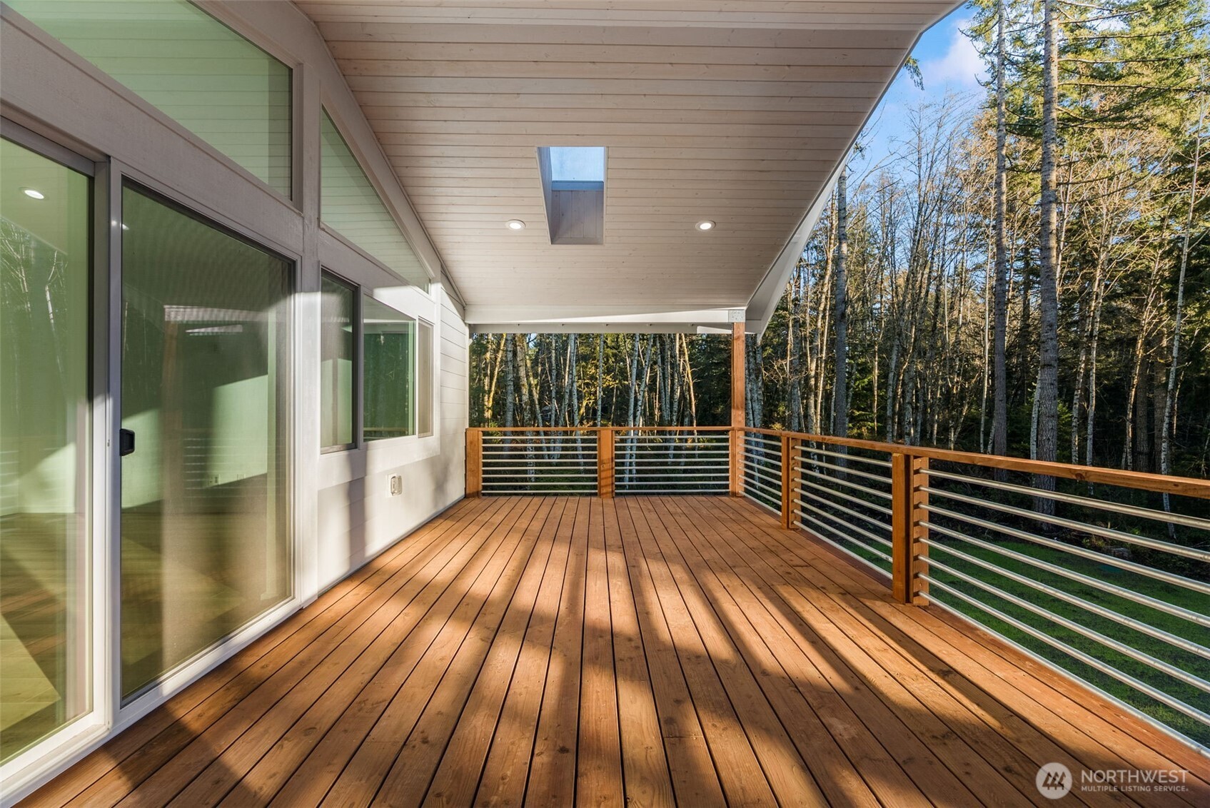6925 Schweitzer Place Southwest Port Orchard, WA 98367 - Photo 17 of 32 a view of deck with wooden floor and floor to ceiling window