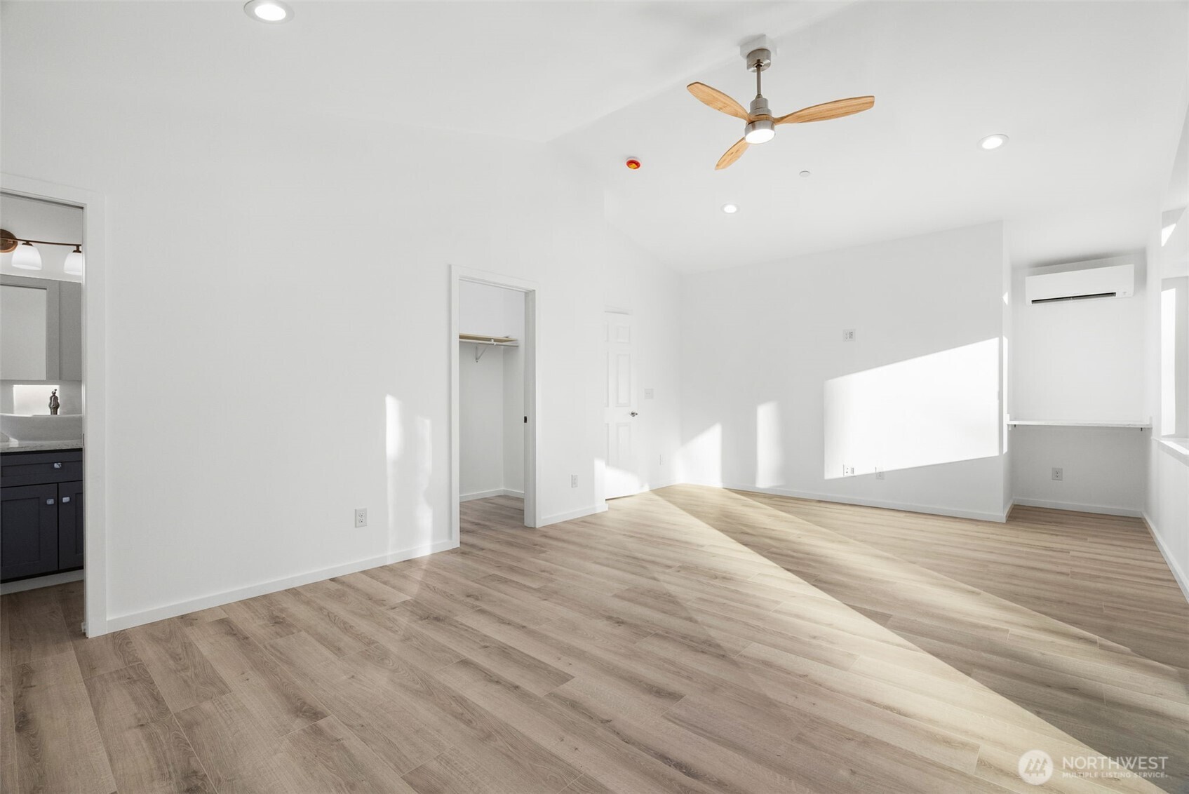 6925 Schweitzer Place Southwest Port Orchard, WA 98367 - Photo 19 of 32 a view of a room with a ceiling fan and wooden floor