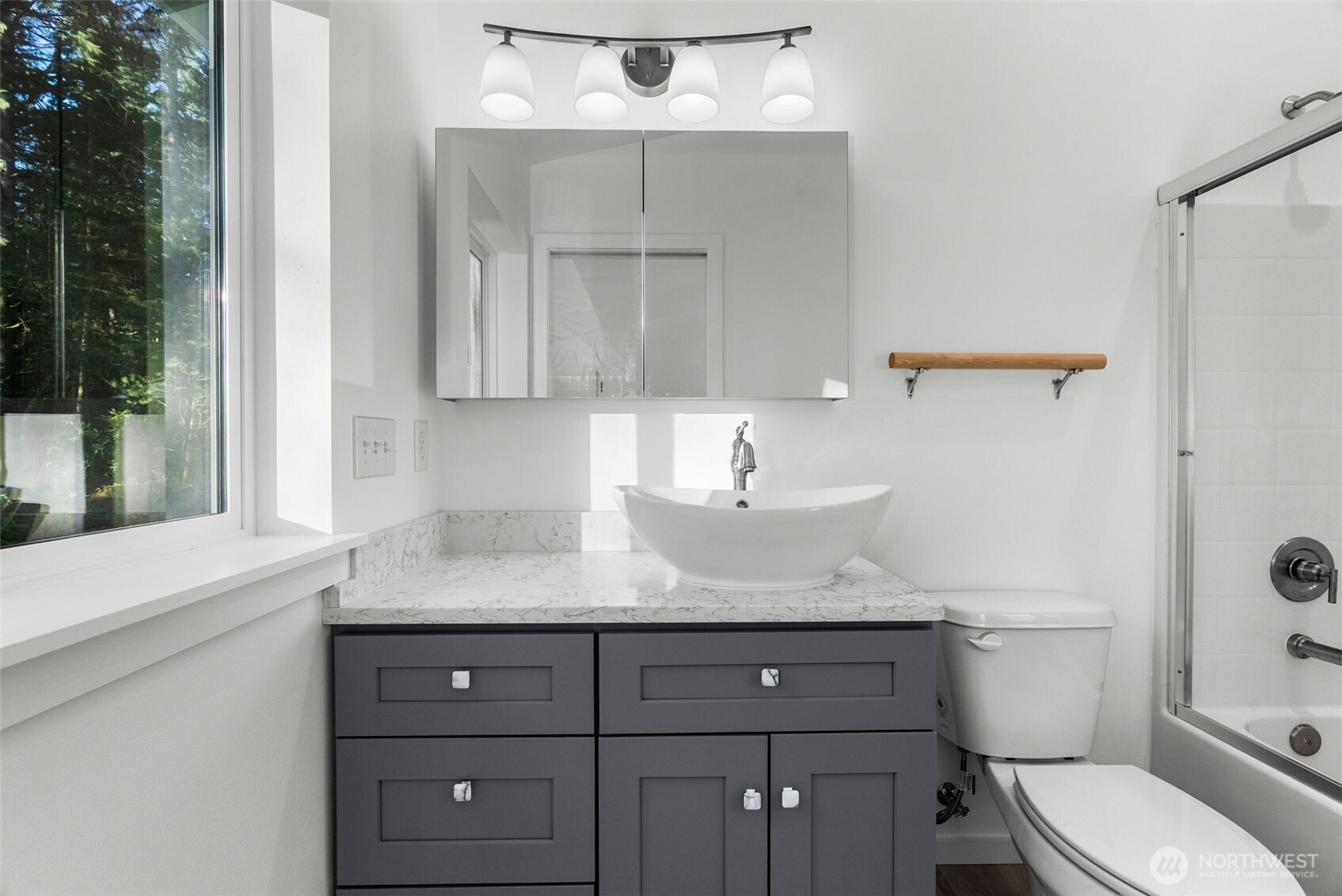 6925 Schweitzer Place Southwest Port Orchard, WA 98367 - Photo 20 of 32 a bathroom with a granite countertop sink a toilet and shower