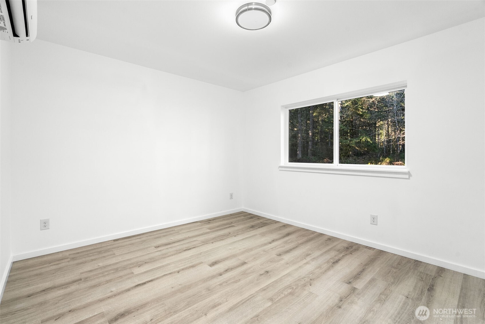 6925 Schweitzer Place Southwest Port Orchard, WA 98367 - Photo 25 of 32 an empty room with wooden floor and windows