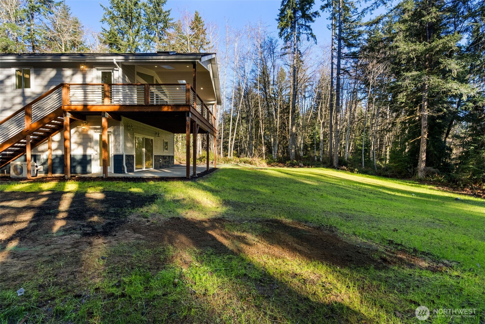 6925 Schweitzer Place Southwest Port Orchard, WA 98367 - Photo 29 of 32 a view of a big house with a big yard and large trees