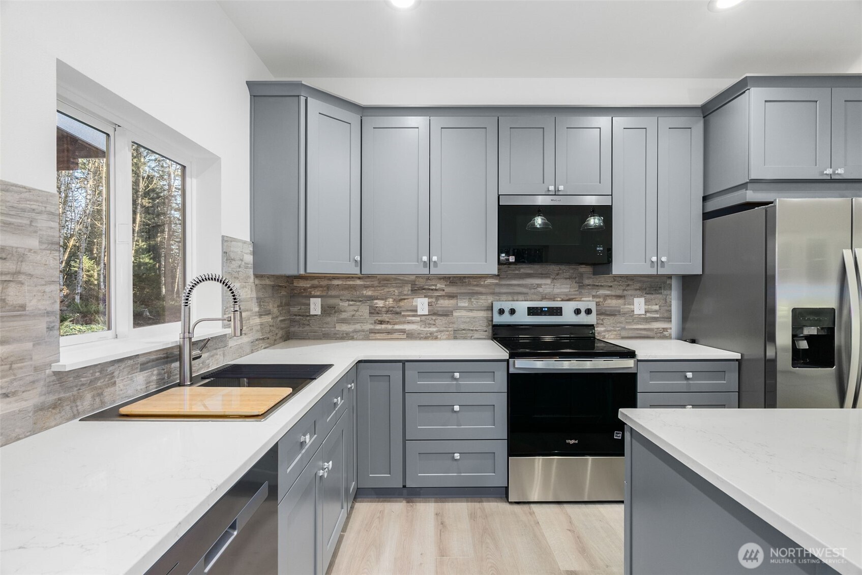 6925 Schweitzer Place Southwest Port Orchard, WA 98367 - Photo 8 of 32 a kitchen with stainless steel appliances granite countertop a sink stove and refrigerator