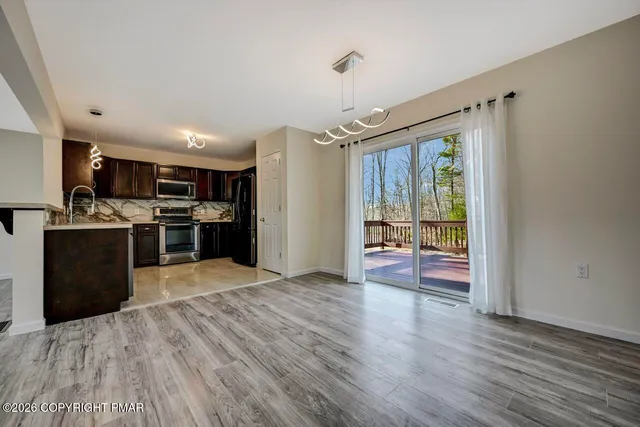 a kitchen with stainless steel appliances granite countertop a refrigerator and a stove top oven