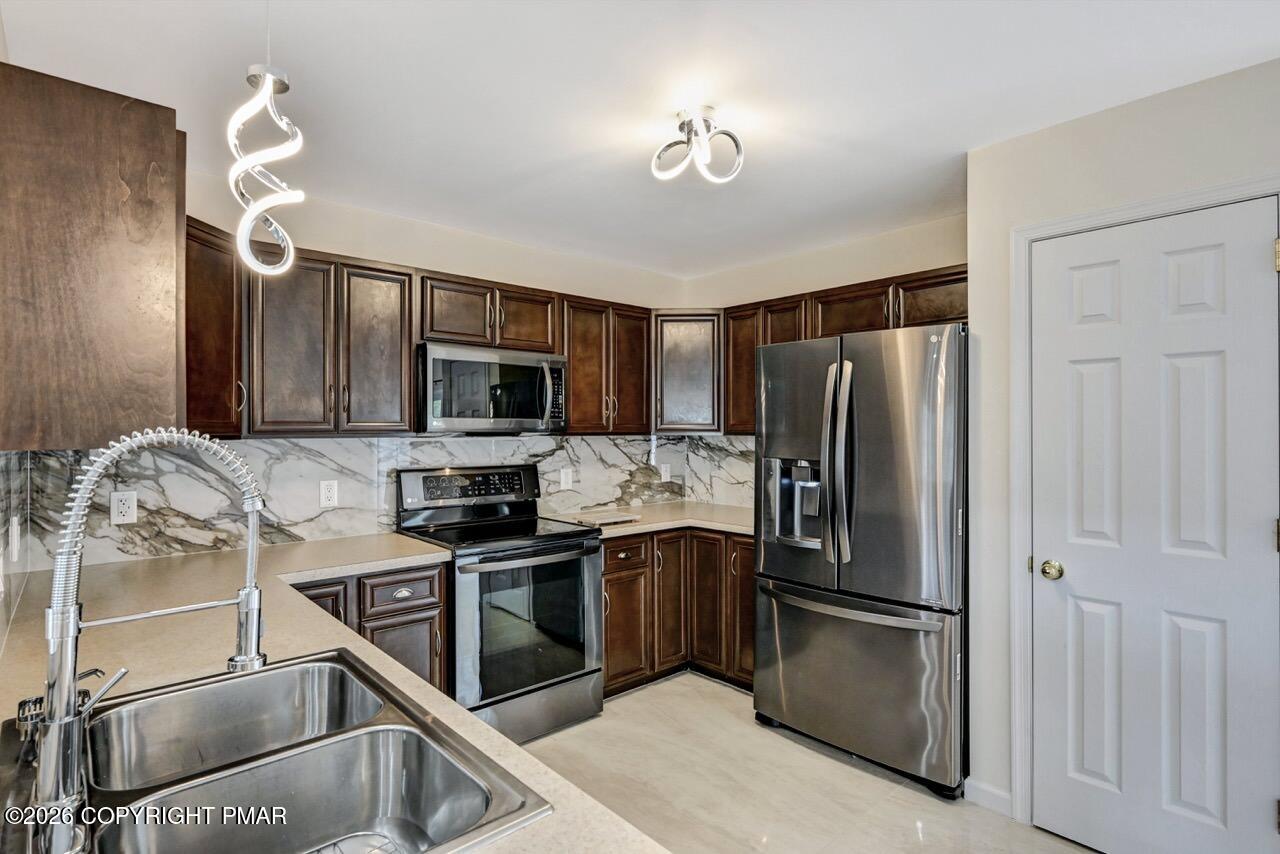 1013 Bear Swamp Road East Stroudsburg, PA 18302 - Photo 15 of 53 a kitchen with stainless steel appliances granite countertop a refrigerator and a stove top oven