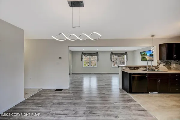 a kitchen with a sink dishwasher a stove and a refrigerator with wooden floor