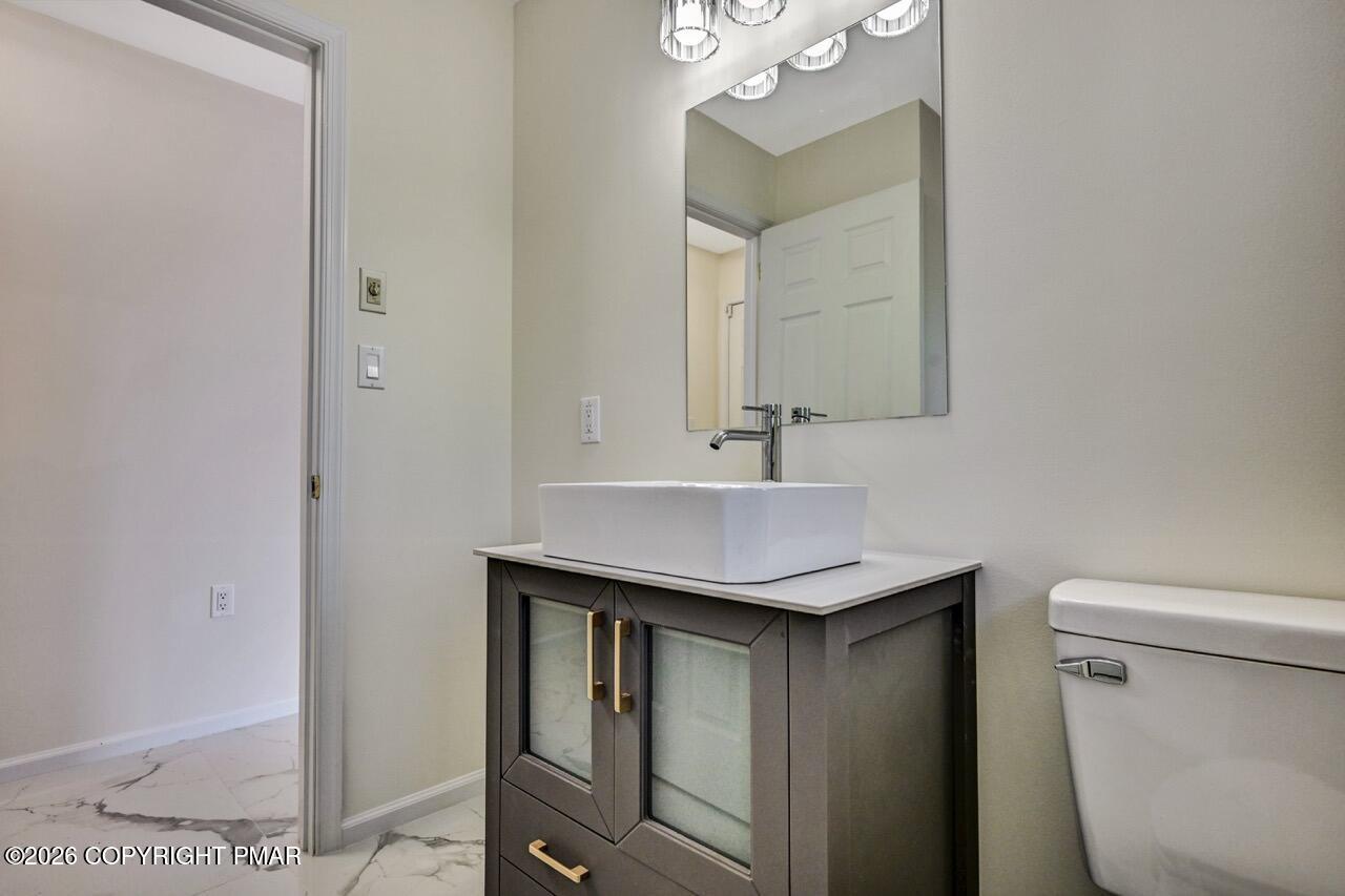 1013 Bear Swamp Road East Stroudsburg, PA 18302 - Photo 20 of 53 a bathroom with a sink a toilet a mirror and shower