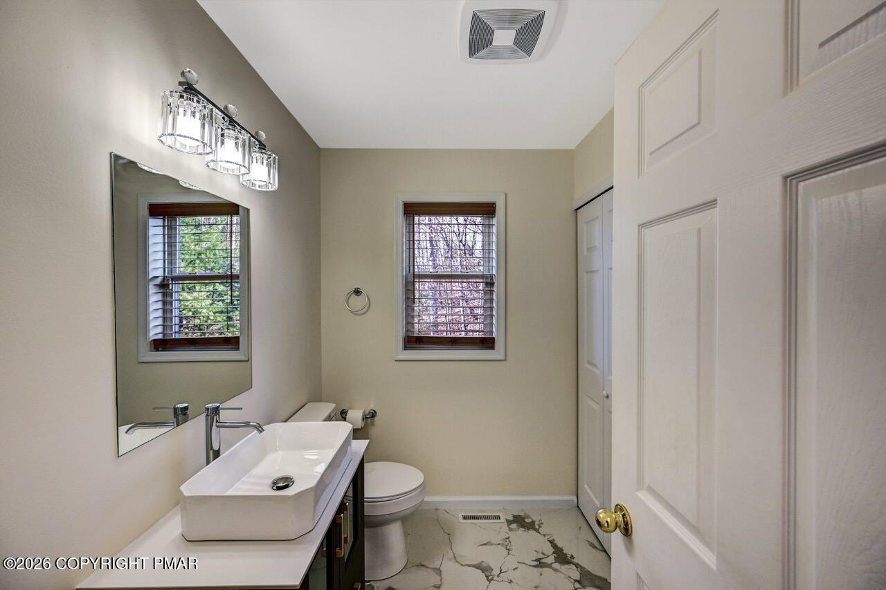 1013 Bear Swamp Road East Stroudsburg, PA 18302 - Photo 21 of 53 a bathroom with a sink a toilet and shower